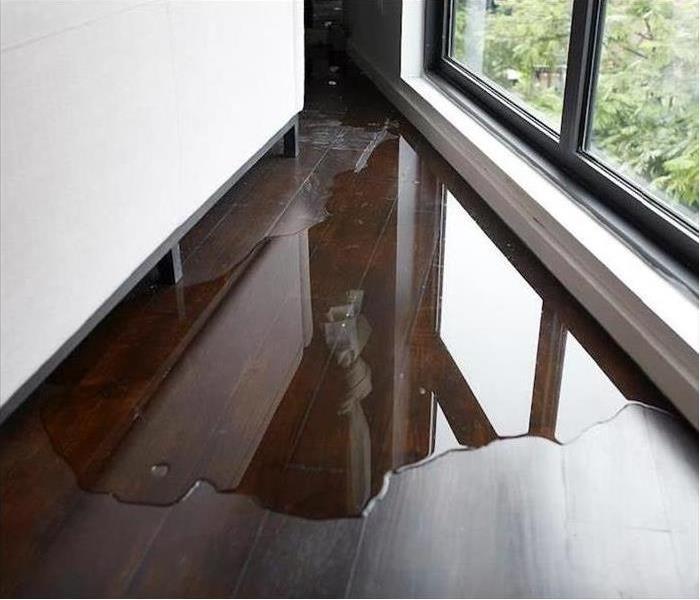 Pool of water on the floor of an office.